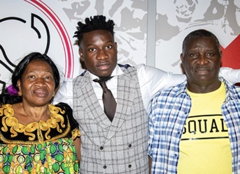 Amadou Onana with his parents.